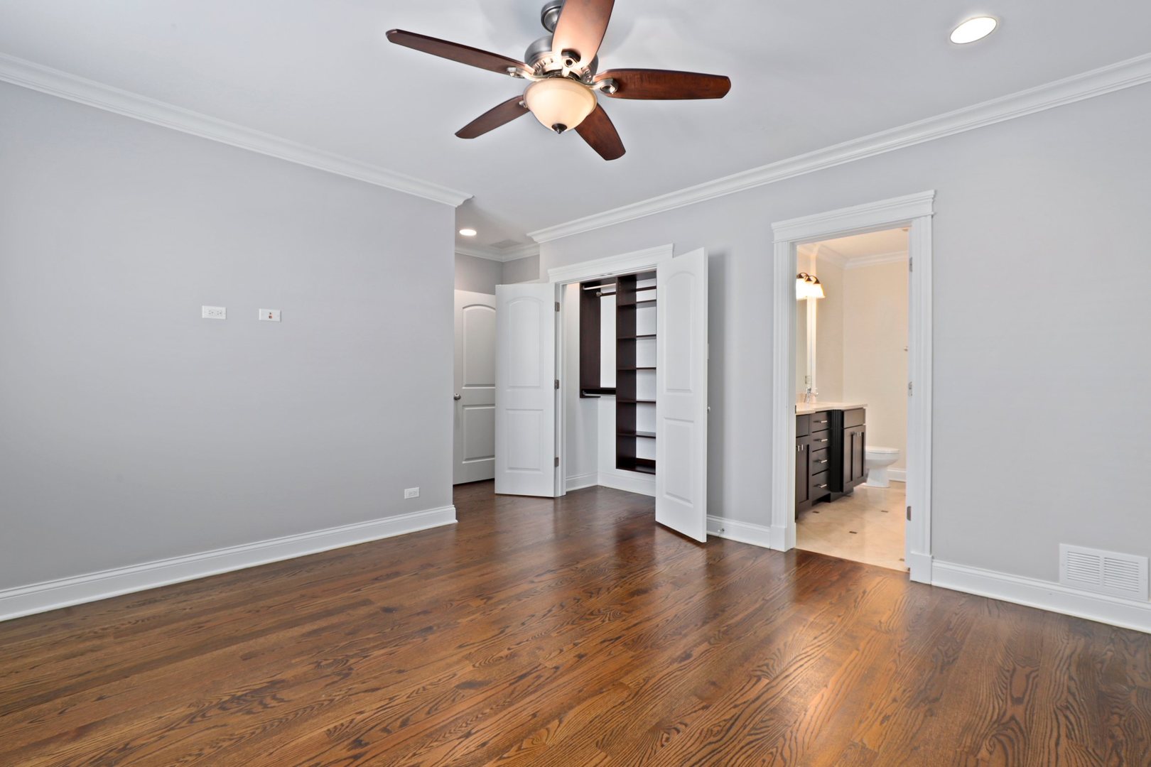 3549 North Reta Avenue, Unit 2 Chicago, IL 60657 - Photo 19 of 30 a view of an empty room with wooden floor and a ceiling fan