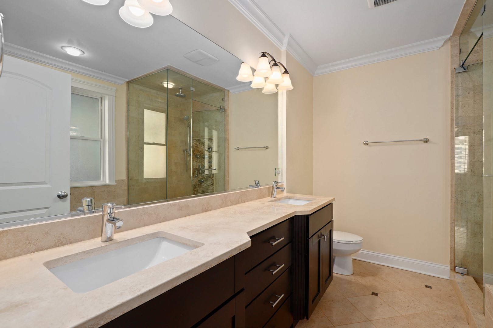 3549 North Reta Avenue, Unit 2 Chicago, IL 60657 - Photo 21 of 30 a bathroom with a granite countertop sink a toilet and a mirror