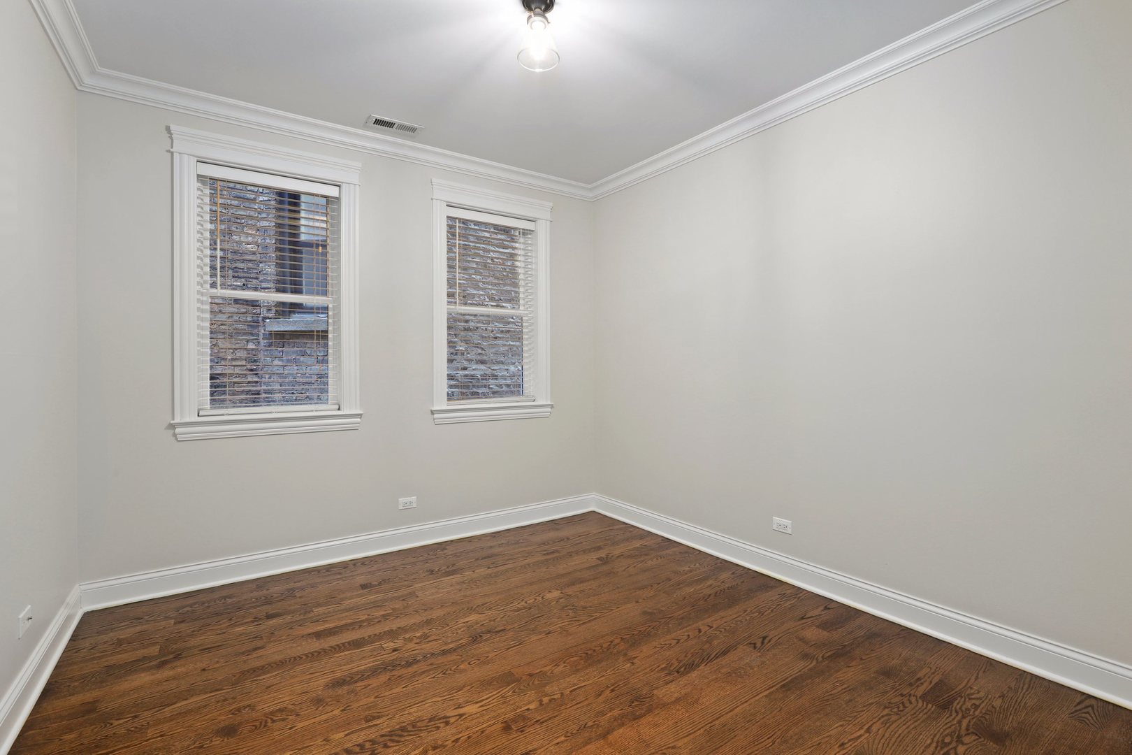 3549 North Reta Avenue, Unit 2 Chicago, IL 60657 - Photo 24 of 30 an empty room with wooden floor and windows