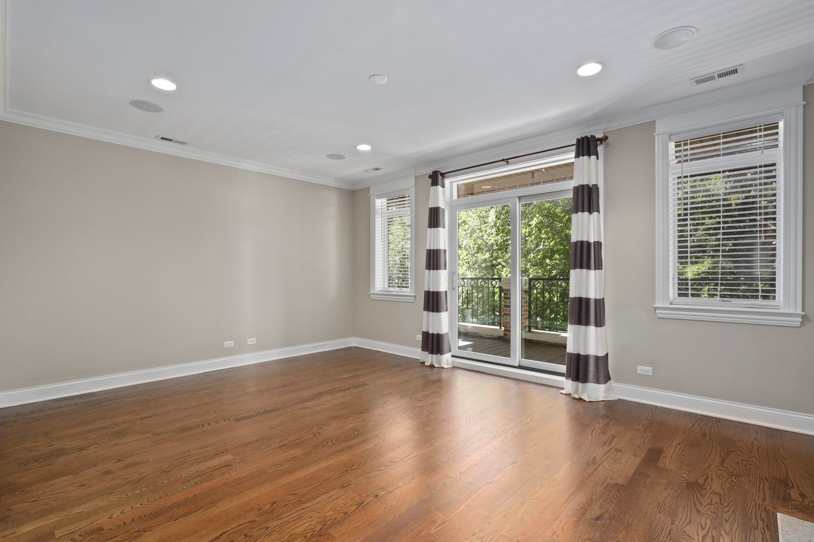 3549 North Reta Avenue, Unit 2 Chicago, IL 60657 - Photo 6 of 30 a view of an empty room with wooden floor and a window