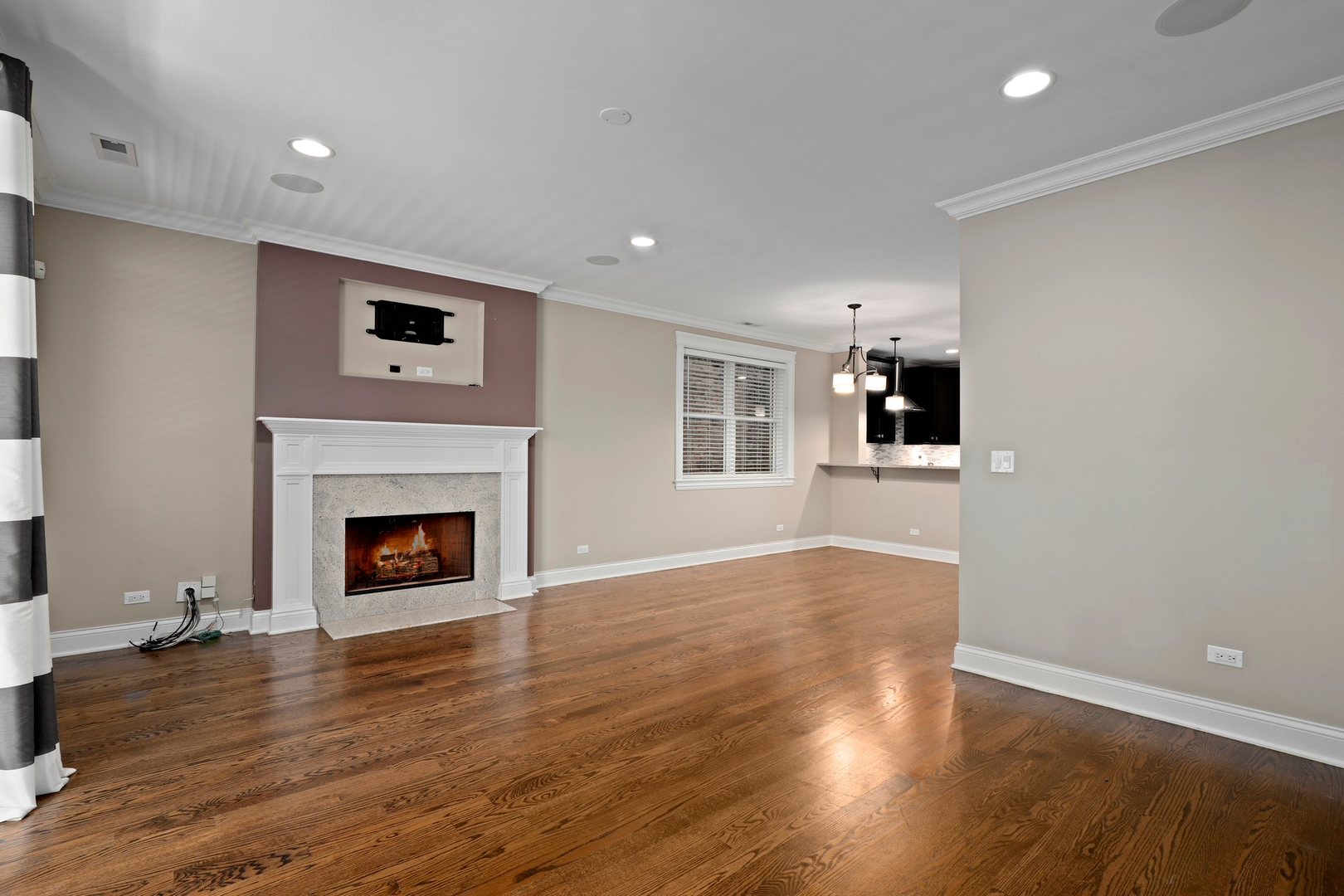 3549 North Reta Avenue, Unit 2 Chicago, IL 60657 - Photo 9 of 30 a view of an empty room with wooden floor and a fireplace