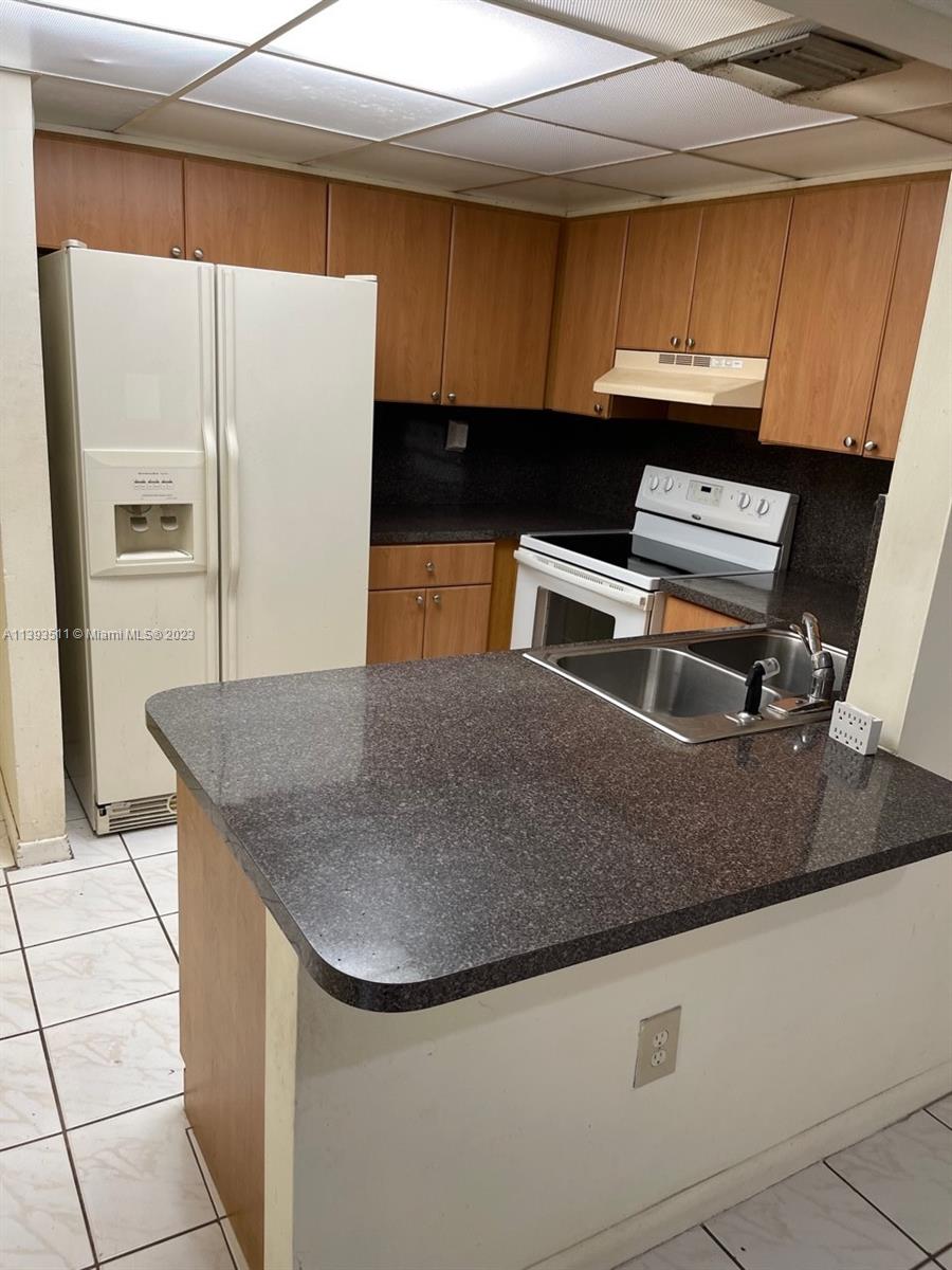 Doral Miami, FL 33172 - Photo 6 of 13 a kitchen with stainless steel appliances granite countertop a sink a microwave and a refrigerator