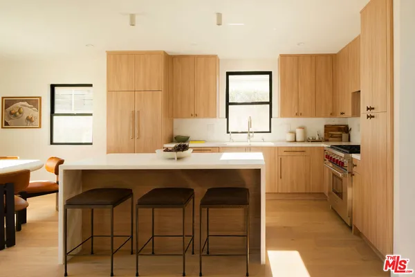 a kitchen with a sink cabinets and window