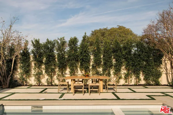 a view of a swimming pool with couches and lounge chairs