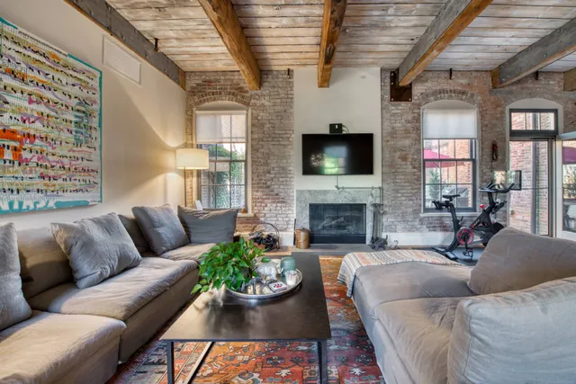 a living room with furniture a flat screen tv and a fireplace
