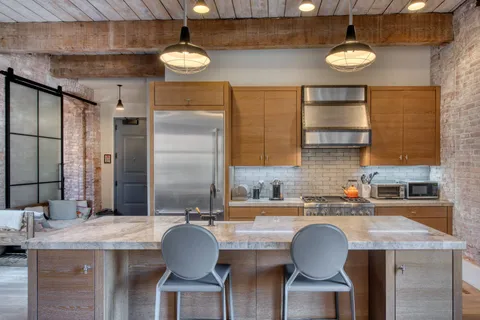 a kitchen with a table chairs sink and cabinets