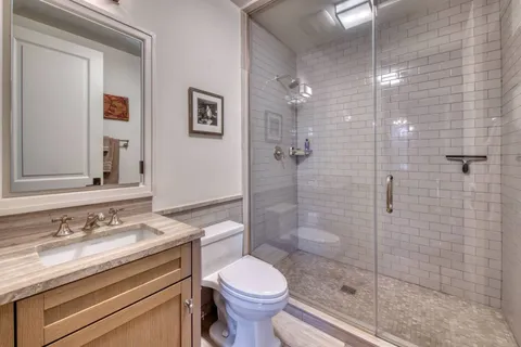 a bathroom with a sink toilet and shower