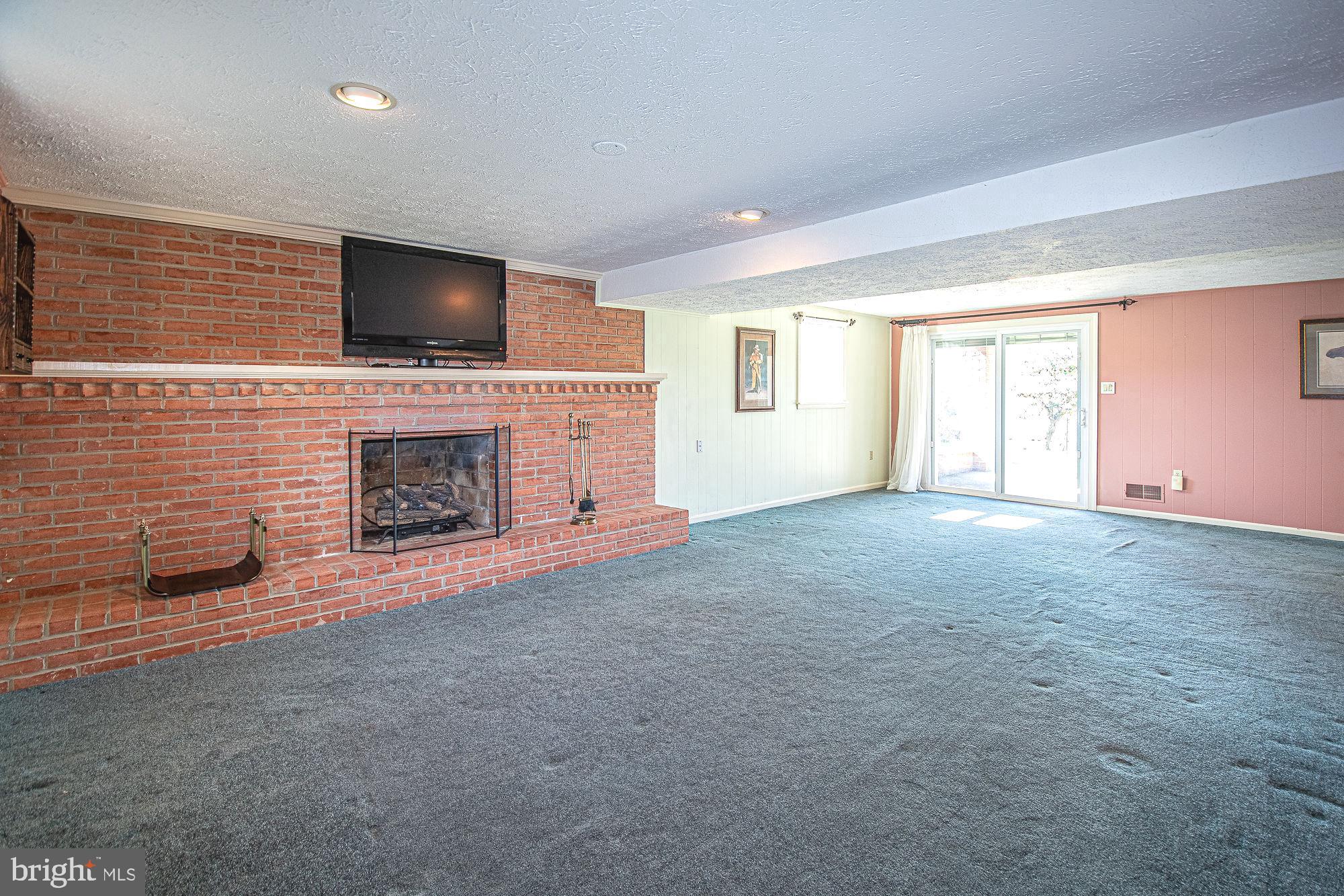7 Ridge Road Front Royal, VA 22630 - Photo 5 of 48 Roomy rec room with gas fireplace and brick wall