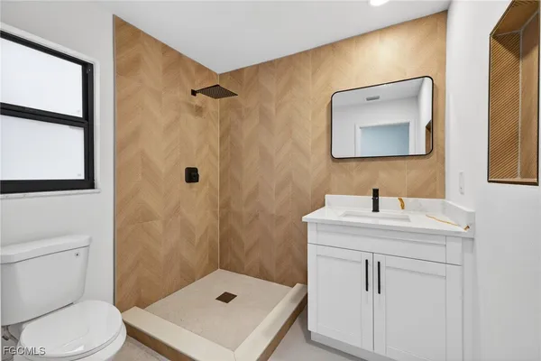 a bathroom with a shower and a toilet