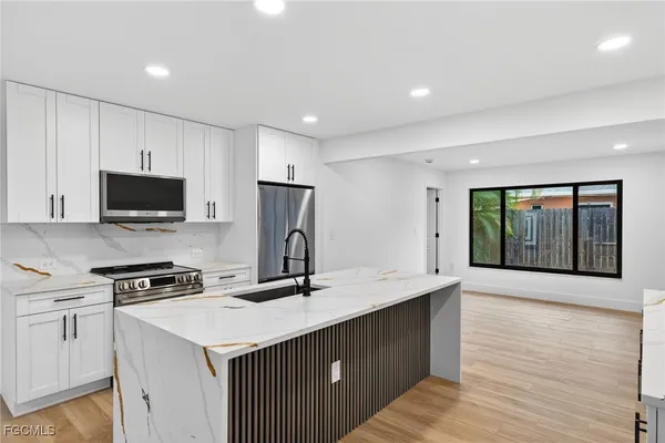 a view of kitchen with furniture and wooden floor