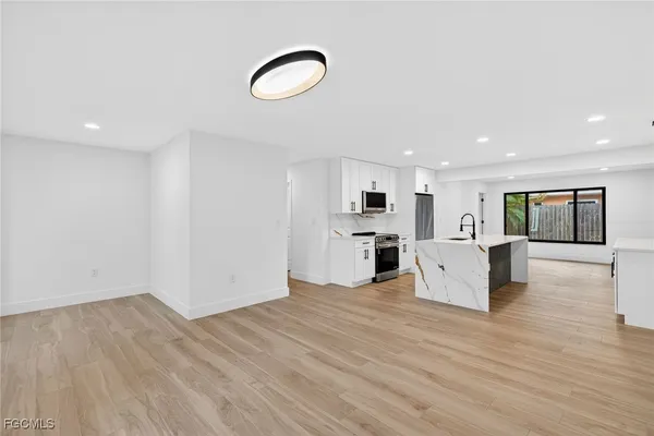a view of a kitchen with furniture and floor to ceiling window
