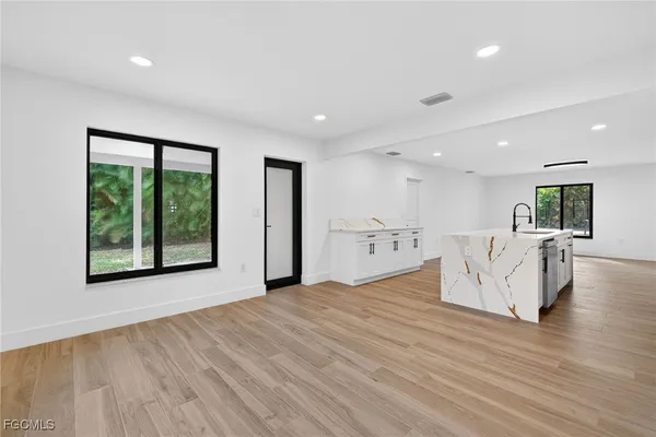 a view of a kitchen with wooden floor
