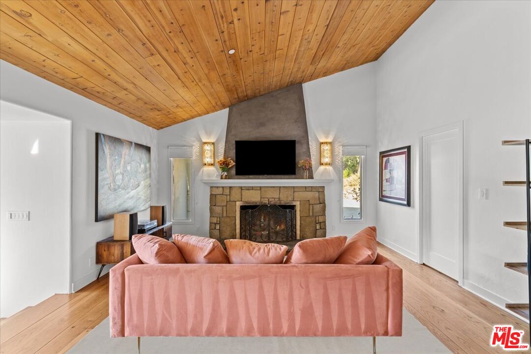 2373 Tuna Canyon Road Topanga, CA 90290 - Photo 17 of 54 a living room with furniture and a fireplace