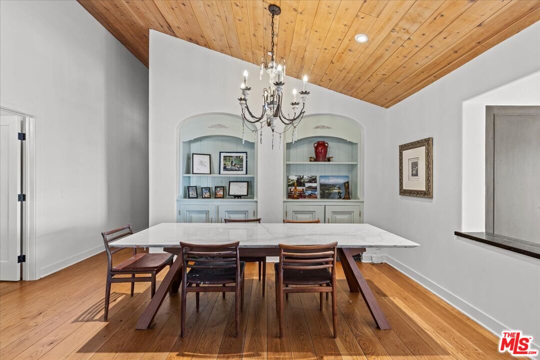 2373 Tuna Canyon Road Topanga, CA 90290 - Photo 18 of 54 a view of a dining room with furniture window and wooden floor
