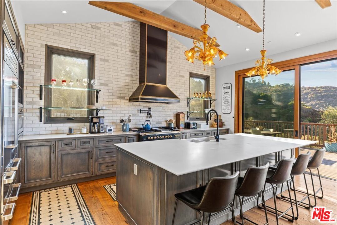 2373 Tuna Canyon Road Topanga, CA 90290 - Photo 2 of 54 a kitchen with a sink a stove and chairs
