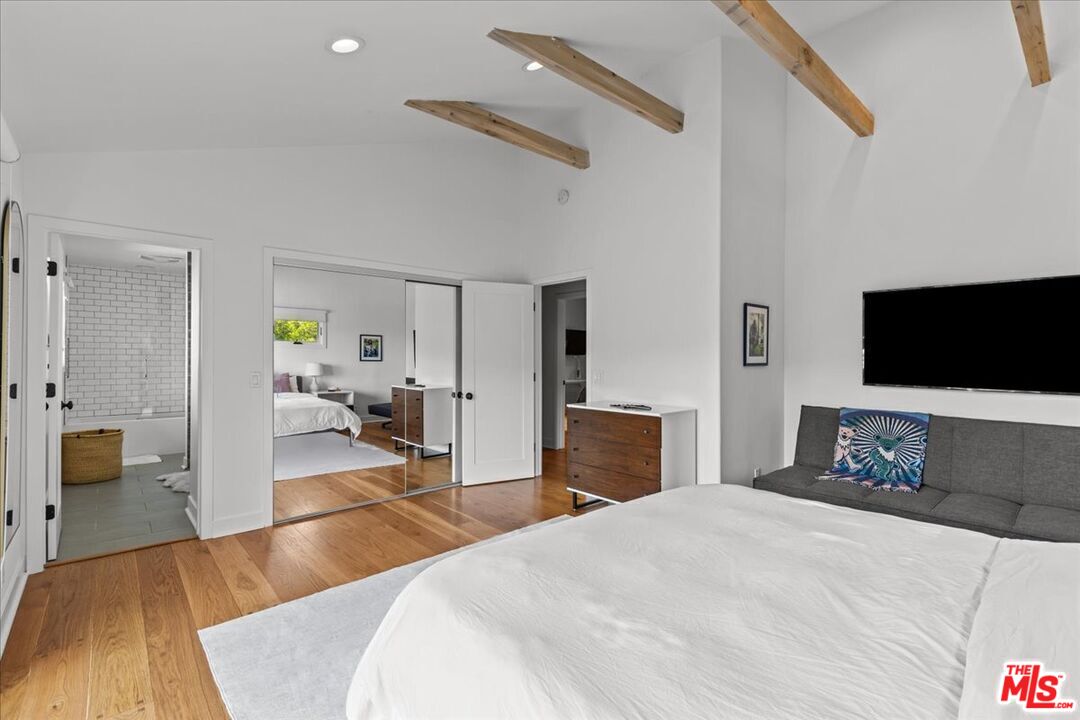 2373 Tuna Canyon Road Topanga, CA 90290 - Photo 26 of 54 a bedroom with a bed and a flat tv screen on wall