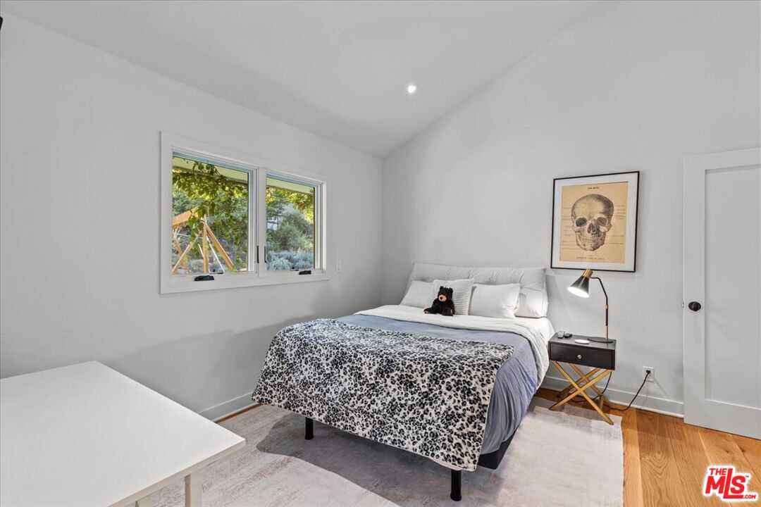 2373 Tuna Canyon Road Topanga, CA 90290 - Photo 33 of 54 a bedroom with a bed and painting on the wall