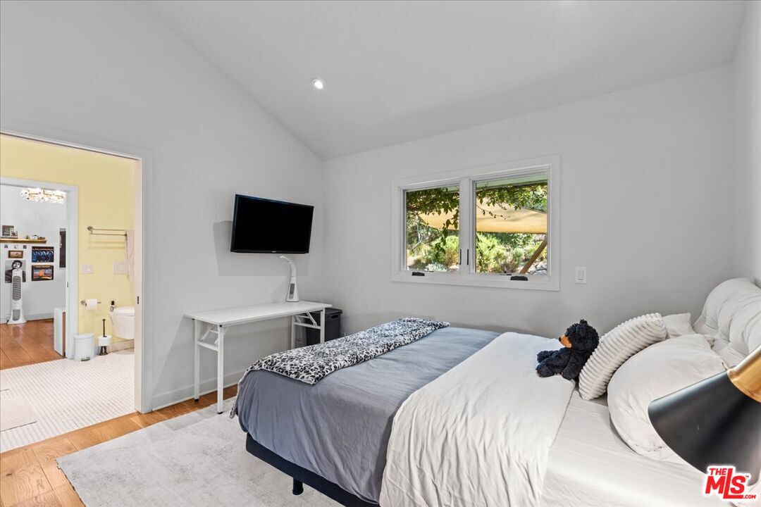 2373 Tuna Canyon Road Topanga, CA 90290 - Photo 34 of 54 a bedroom with a bed and a flat screen tv