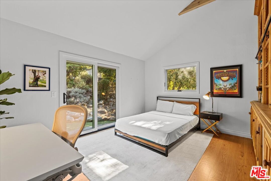 2373 Tuna Canyon Road Topanga, CA 90290 - Photo 35 of 54 a bedroom with a bed and a large window