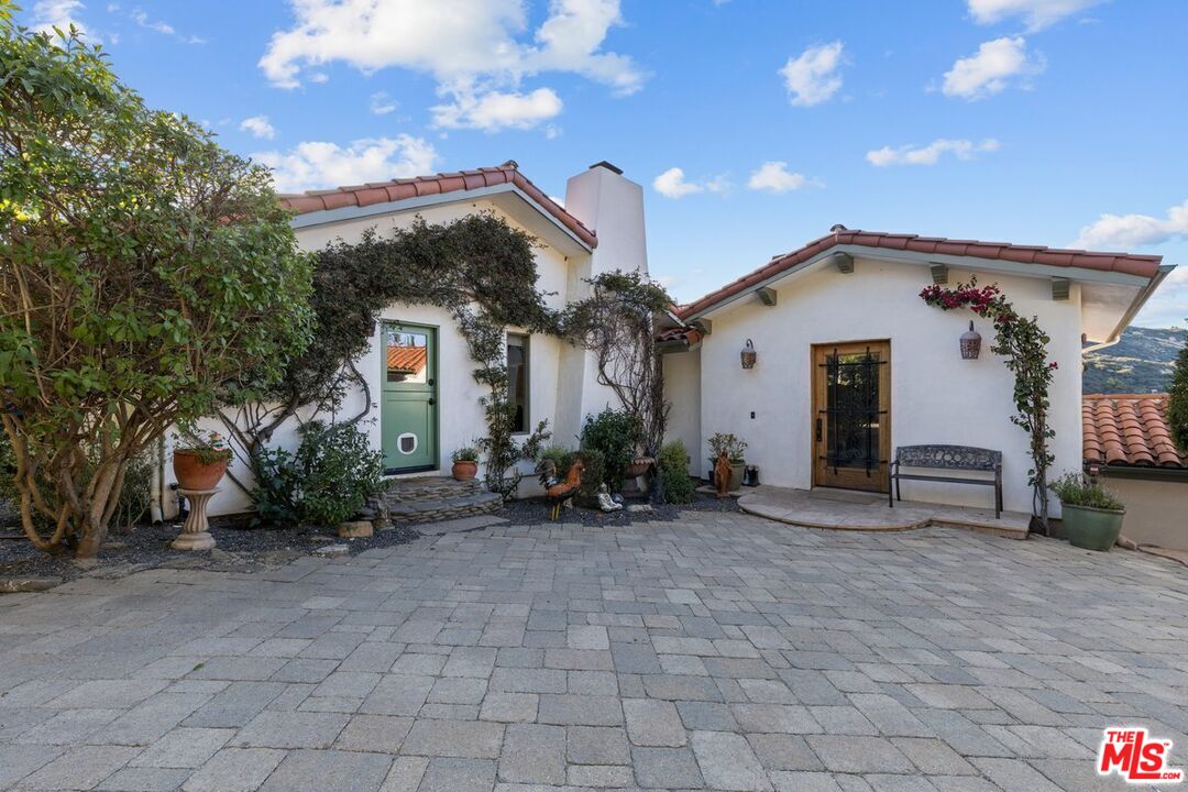 2373 Tuna Canyon Road Topanga, CA 90290 - Photo 41 of 54 a view of a house with a small yard and a large tree