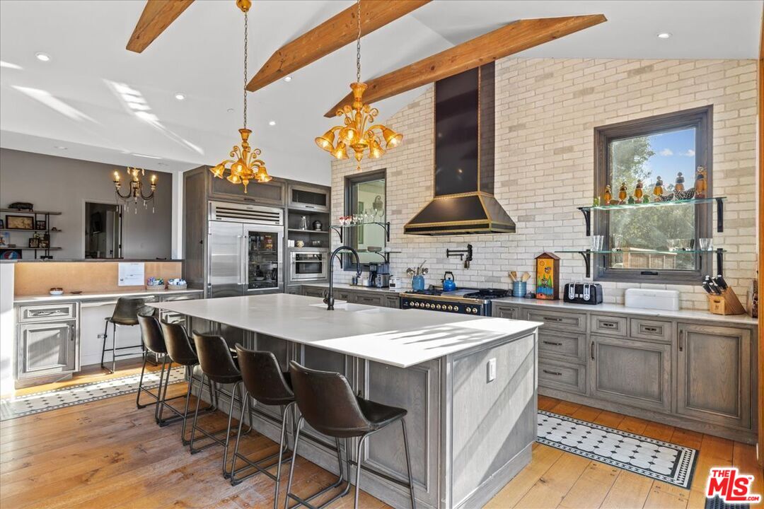 2373 Tuna Canyon Road Topanga, CA 90290 - Photo 5 of 54 a open kitchen with stainless steel appliances granite countertop a sink and a refrigerator