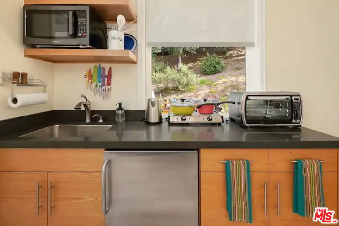 2373 Tuna Canyon Road Topanga, CA 90290 - Photo 53 of 54 a kitchen with stainless steel appliances granite countertop a sink and a microwave