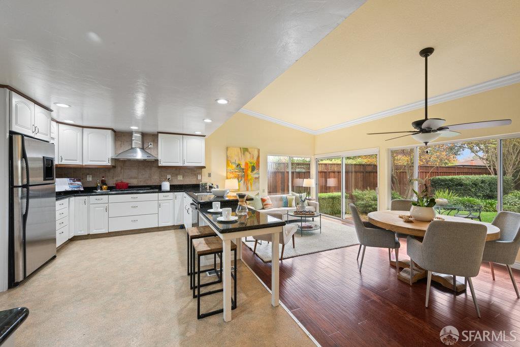 4572 Ross Gate Way Pleasanton, CA 94566 - Photo 13 of 58 a kitchen with a table chairs refrigerator and cabinets