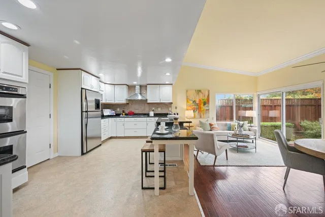 a kitchen with stainless steel appliances granite countertop a stove refrigerator sink and cabinets