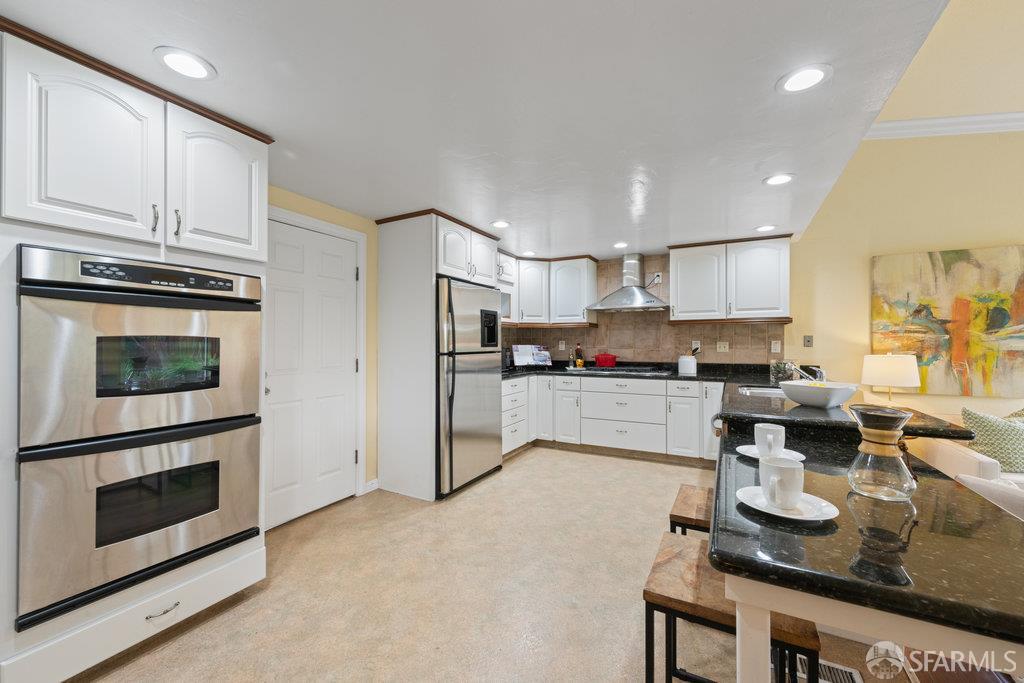 4572 Ross Gate Way Pleasanton, CA 94566 - Photo 15 of 58 a kitchen with stainless steel appliances granite countertop a stove refrigerator sink and cabinets