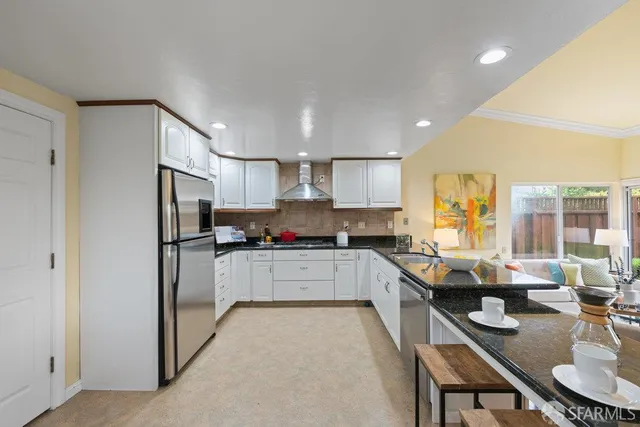 a kitchen with a sink and appliances