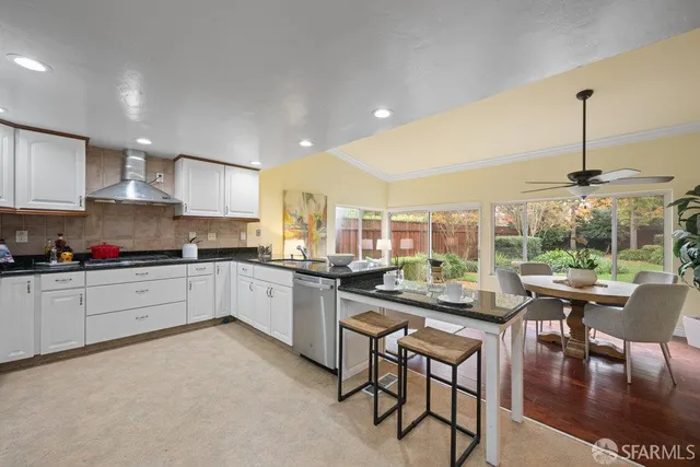 a kitchen with a sink appliances and cabinets