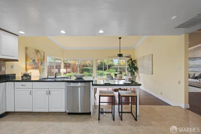 a kitchen with stainless steel appliances a refrigerator sink and stove