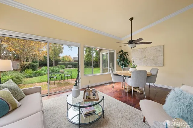 a kitchen with a table chairs microwave and cabinets