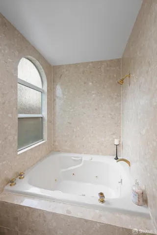 a bedroom with a bed and a chair