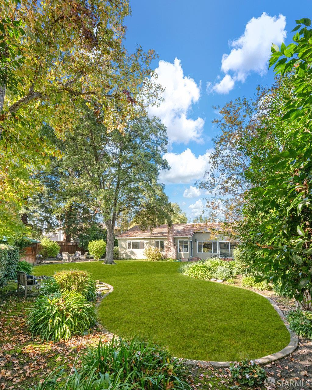 4572 Ross Gate Way Pleasanton, CA 94566 - Photo 49 of 58 a view of a white house with a big yard and large trees