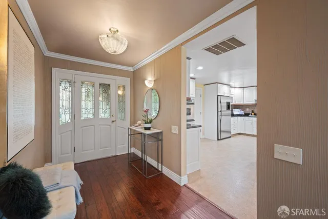 a very nice looking room with a large bed and wooden floor