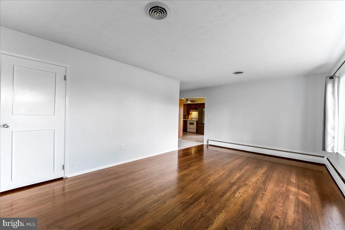 158 Firetower Road Port Deposit, MD 21904 - Photo 6 of 50 an empty room with wooden floor and windows