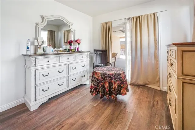 a bedroom with a large bed and a chandelier fan