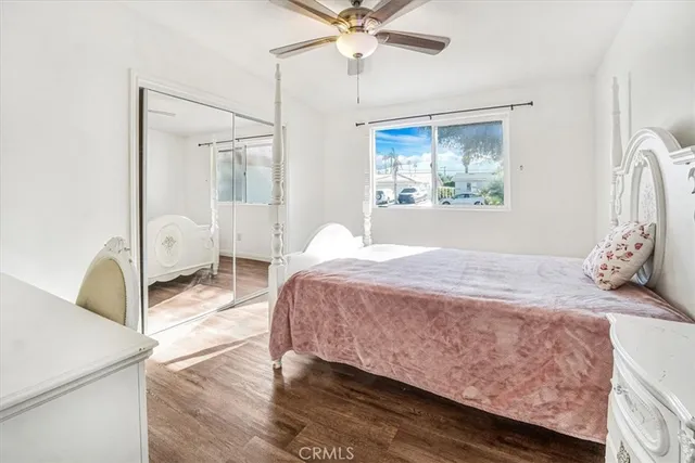 a view of a bedroom with wooden floor