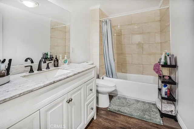 a bathroom with a granite countertop toilet a sink and bathtub