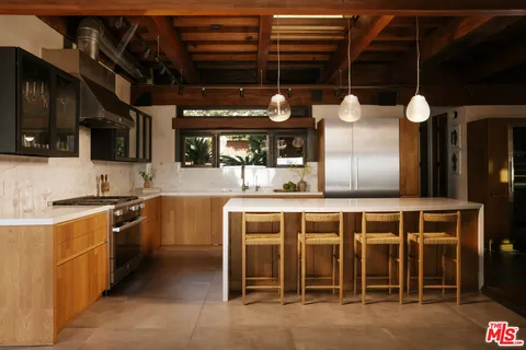 a view of living room filled with furniture and a large window