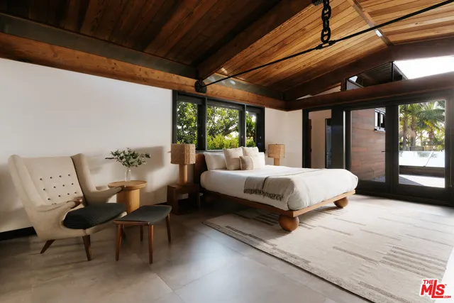 a bedroom with furniture and a window