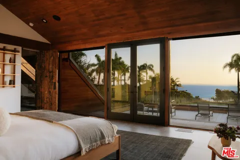 a terrace with outdoor seating and city view