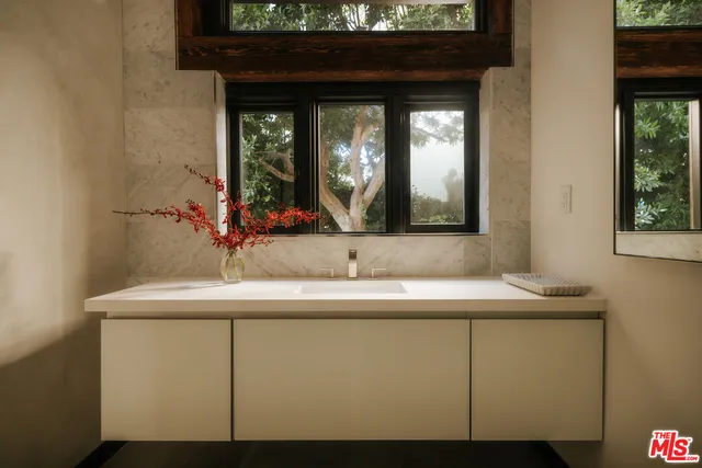 a bedroom with a bed and a large window