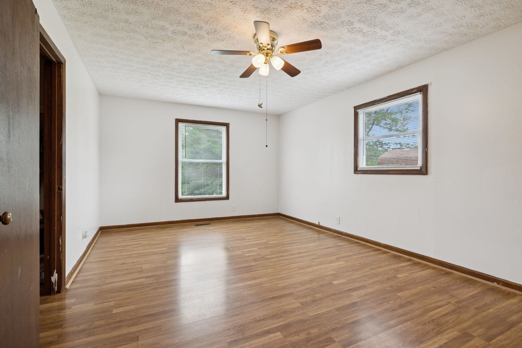 115 White Road Portland, TN 37148 - Photo 26 of 44 a view of an empty room with wooden floor and a ceiling fan