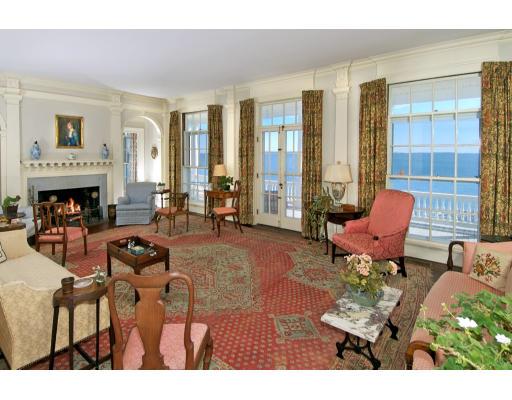 22 Crowninshield Road Marblehead, MA 01945 - Photo 3 of 6 a living room with furniture a fireplace and large windows