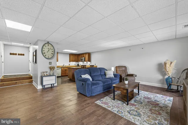 a living room with furniture and a clock