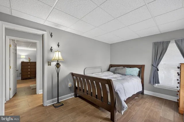 a bedroom with a bed and a mirror