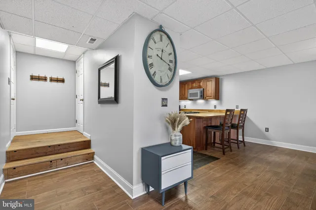 a room with furniture and a clock on the wall