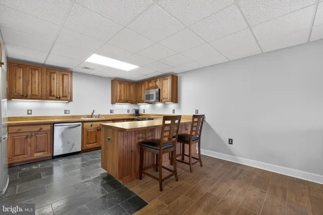 a kitchen with a sink cabinets and wooden floor